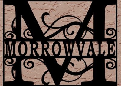 A black and white metal sign displaying the word "Morrowvale" prominently in a bold font.