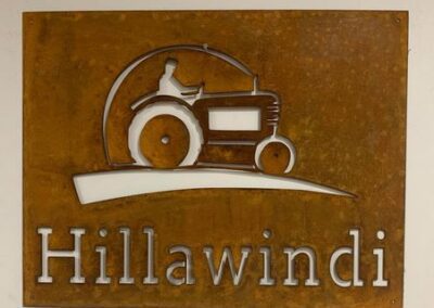 A metal sign displaying the word "hillawindi" prominently, set against a neutral background.