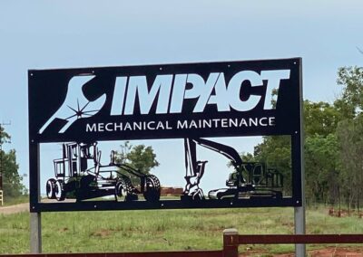 A sign displaying the words "Impact Mechanical Maintenance" in bold letters, indicating a service area for mechanical upkeep.