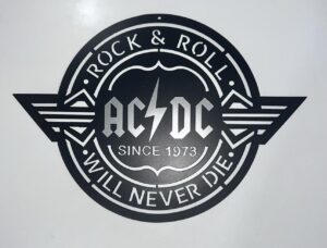 Logo of AC/DC with the text "Rock & Roll Will Never Die" and "Since 1973" on a circular badge.