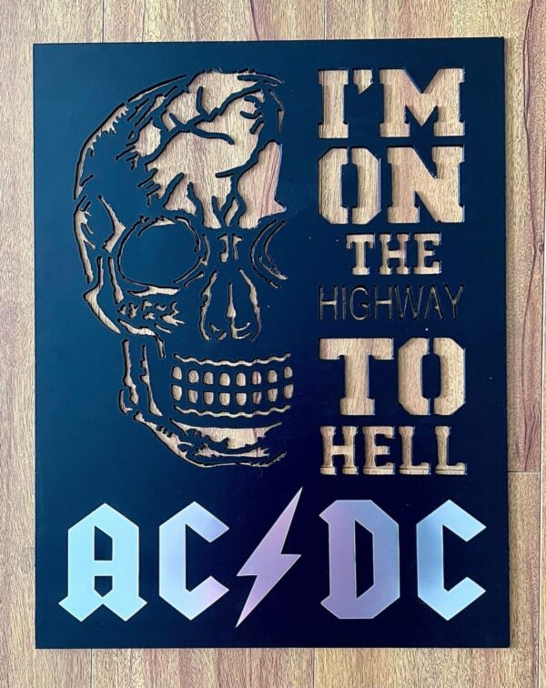 Metallic skull cutout with "I'M ON THE HIGHWAY TO HELL AC/DC" text on a blue background.