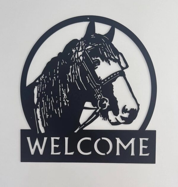 Black metallic welcome sign featuring a horse head within a circular frame.