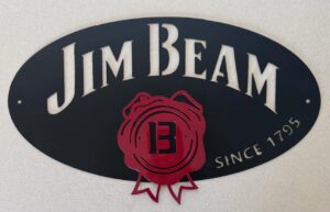 Oval "Jim Beam" logo with a wax seal design and "Since 1795" text on a textured surface.