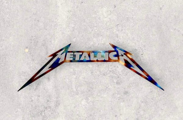 Metallica band logo with iconic font and lightning bolt on concrete background.