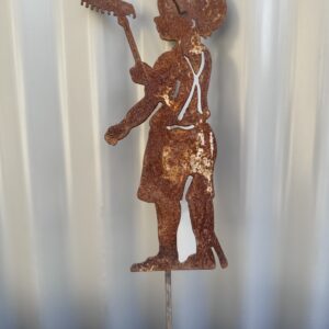 Rusted metal garden silhouette of a girl holding a rake, against a corrugated background.