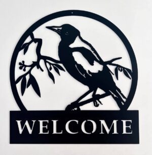 Circular black silhouette of a bird on branches with a "WELCOME" sign below.