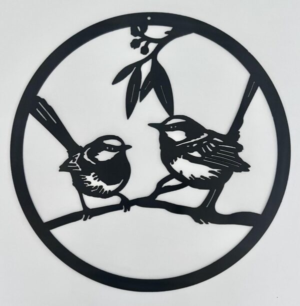 Black metal wall art of two birds perched on a branch within a circular frame.