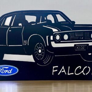 Silhouette of a Ford Falcon car with logo and model name on display stand.