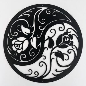 Black and white circular yin-yang symbol with floral patterns.