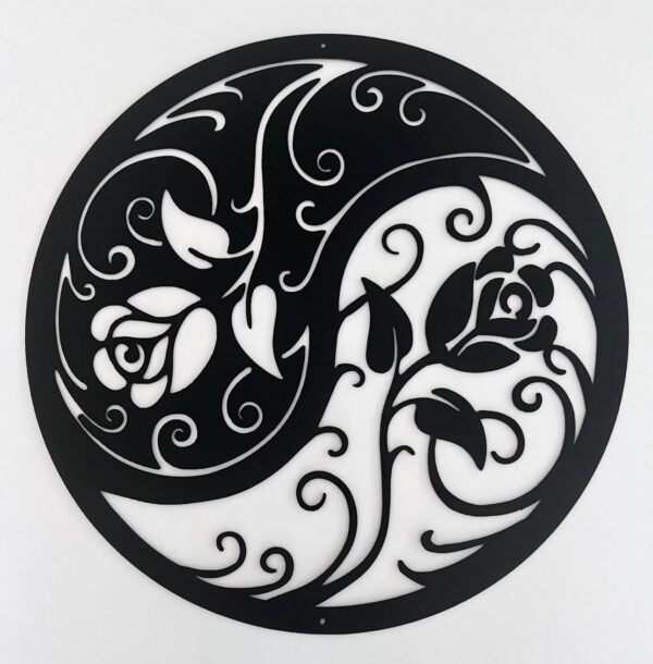 Black and white circular yin-yang symbol with floral patterns.