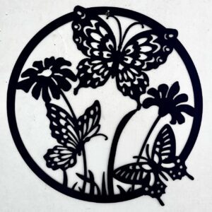 Circular black metal wall art featuring silhouettes of butterflies and flowers.