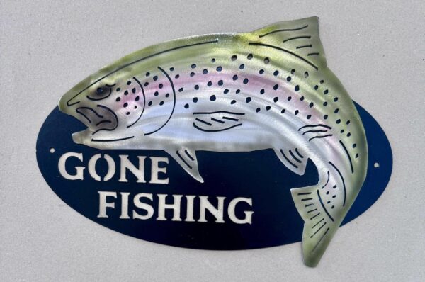 Metallic fish-shaped sign with "GONE FISHING" text on a navy blue background.