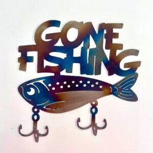 Decorative "GONE FISHING" sign with fish and hooks on a white wall.