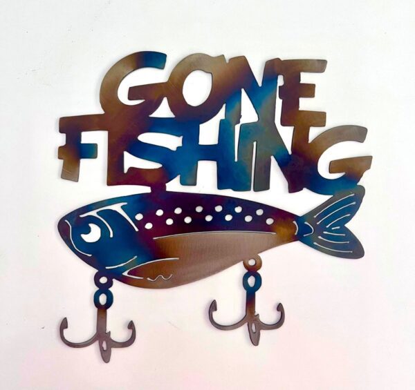 Decorative "GONE FISHING" sign with fish and hooks on a white wall.