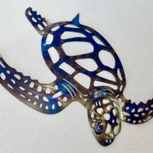 A colorful metallic turtle-shaped cut-out on a light background.