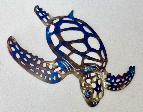 A colorful metallic turtle-shaped cut-out on a light background.