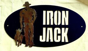 Oval sign with silhouette of a man and dog beside "IRON JACK" in bold letters.