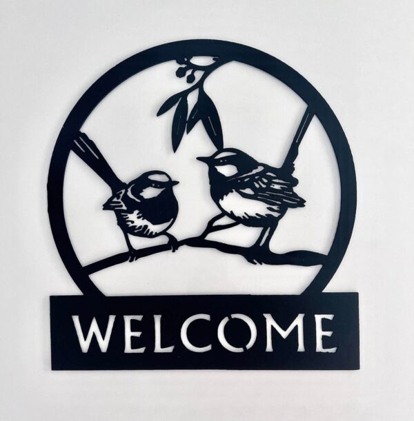 Black metal welcome sign with silhouette of two birds on a branch.