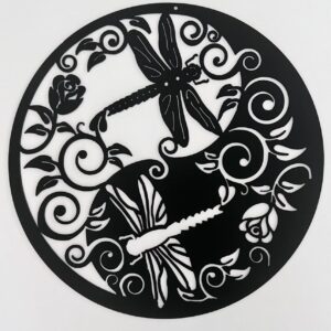 Black circular metal wall art with intricate floral and dragonfly design on a white background.